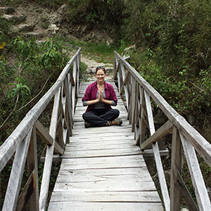 Laurie Lee in Namaste pose on bridge